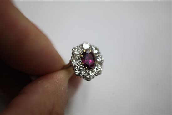 An 18ct white gold, ruby and diamond cluster ring, size N.